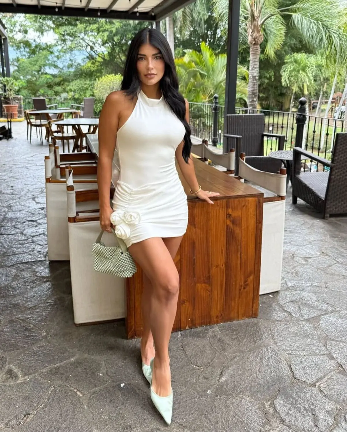 White mini dress at a beach club