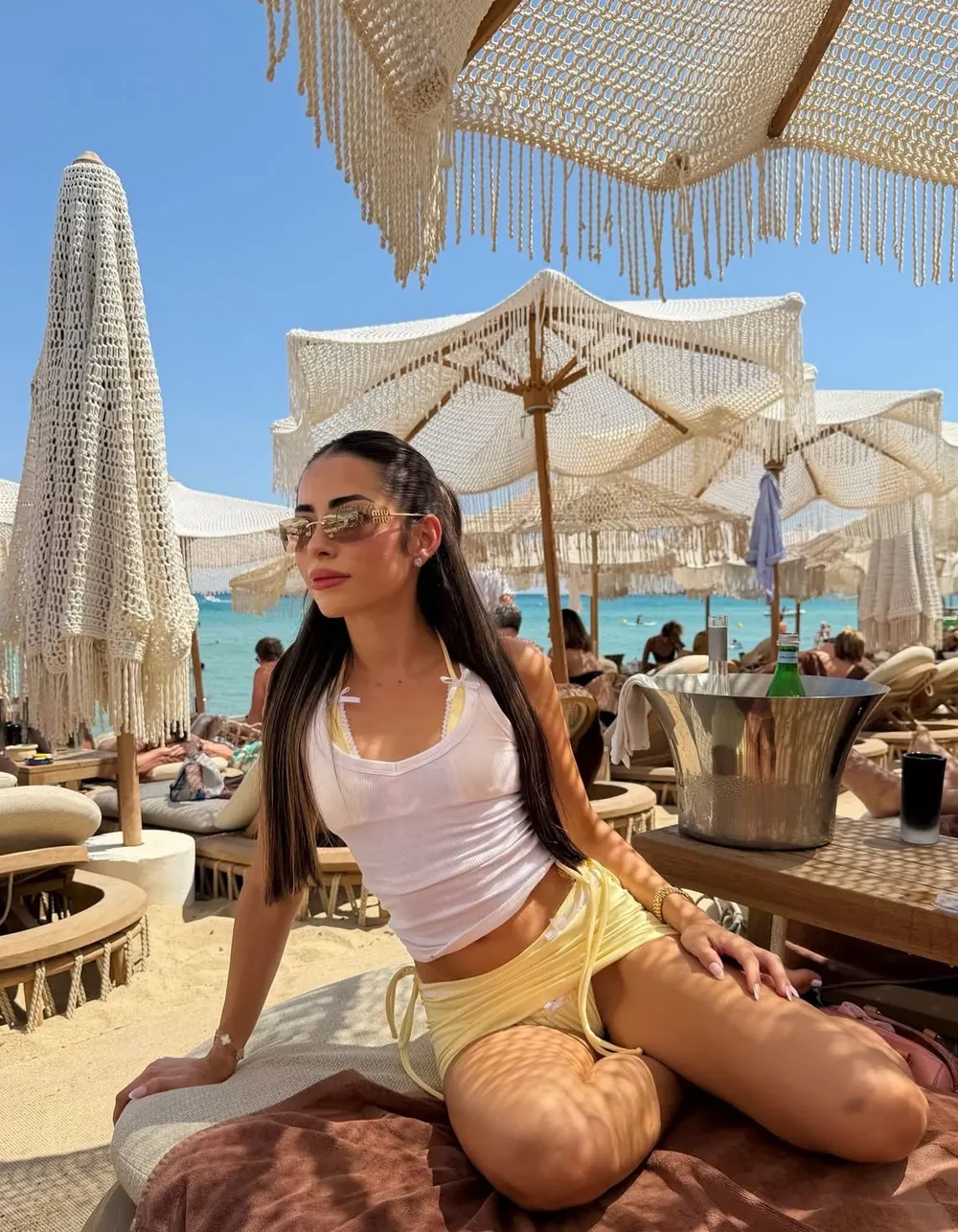 White tank and yellow shorts at the beach club